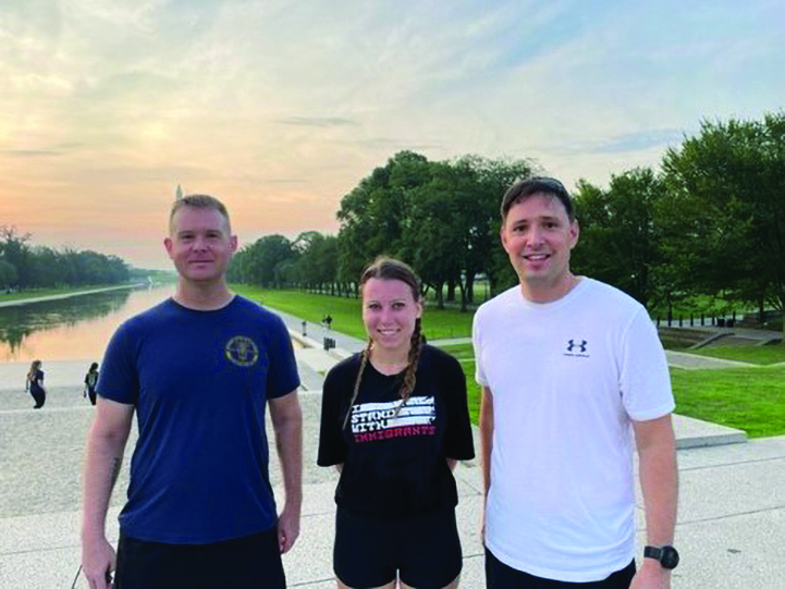 MAJ Mitchell Herniak (left), MAJ Robert
            Rodriguez (right), and Ms. Megan LeG
            -
            resley (center) (Defense Appellate Division
            summer intern) prior to running the 248th
            JAG Corps Birthday 5K on 26 July 2023.
            (Credit: LTC Autumn R. Porter)